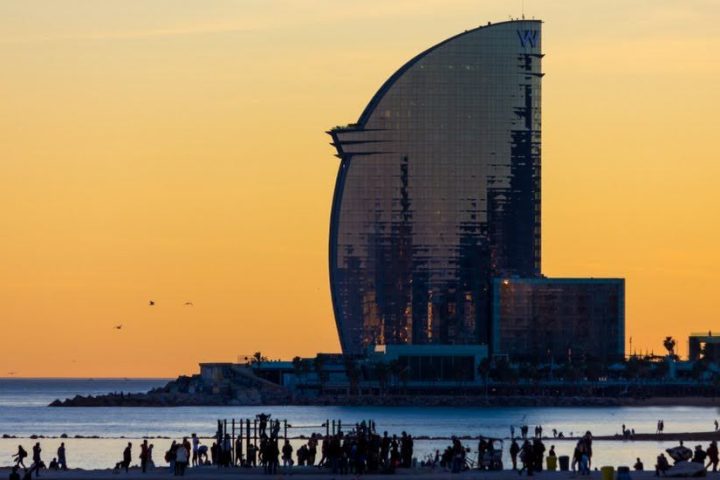 a sunset over a body of water with a city in the background